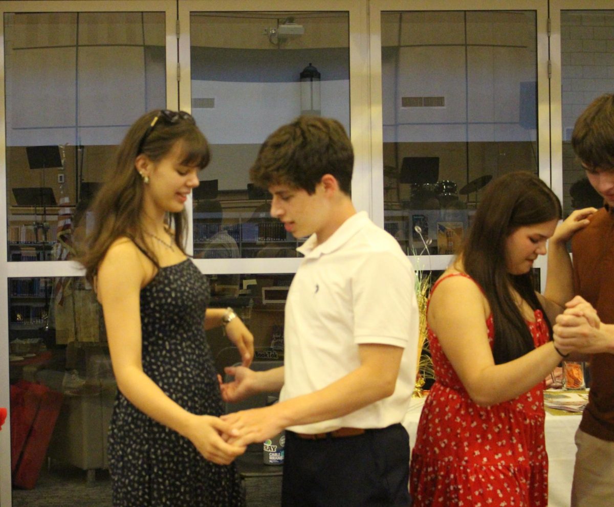 Junior Joy Manning and sophomore Jacob Rhoads dance with each other after the instructors finished showing the swing dance technique. Photograph by Lilly Kruzic