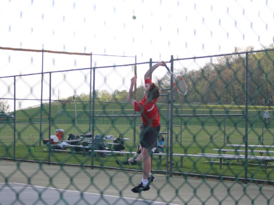 Sophomore Aiden Turk serves the ball during his number 2 singles match while playing against Red Lion.  Turk and Senior captain Jacob Iwanowicz won a  doubles match against York Suburban earlier this season. As the Warriors’ top two singles players, they don’t get to also play doubles for points during league matches. But they will be able to team up for postseason play. 
Photograph by Avery Brenneman