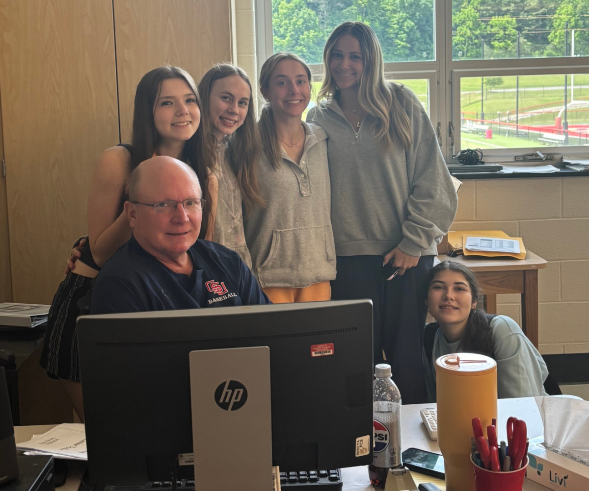 History teacher Bill Kerr smiles with juniors Lilly Huber, Marissa Milano, Alyssa Martin, Olivia Fried and Danica Krebs.
Photograph by Alex Kinard
