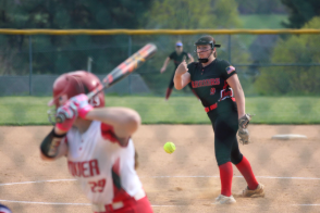 Junior Ella Wetzel fires a pitch from the mound during the home game against Dover. Wetzel had 12 strikeouts in the game, officially surpassing the 100‑strikeout mark for the season solidifying her role as one of the Warriors’ most reliable pitchers. “I feel really good about it,” said Wetzel. Photograph by of Tim Hare